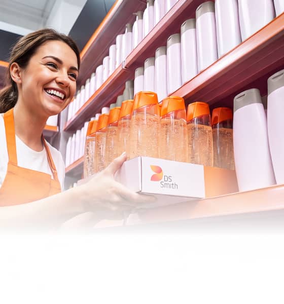 Employee stocking DS Smith packaged products on retail shelves.