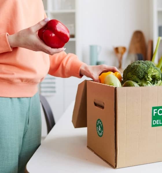 a red pepper in a persons hand