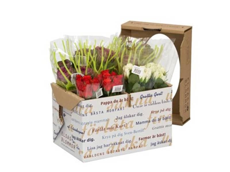 Eine geöffnete Verpackung aus Wellpappe befüllt mit bunten Blumen.