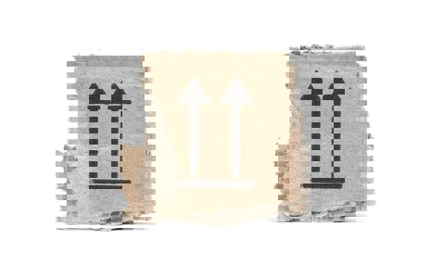 Stukje karton voor recycling, bedrukt met this side up pijlen