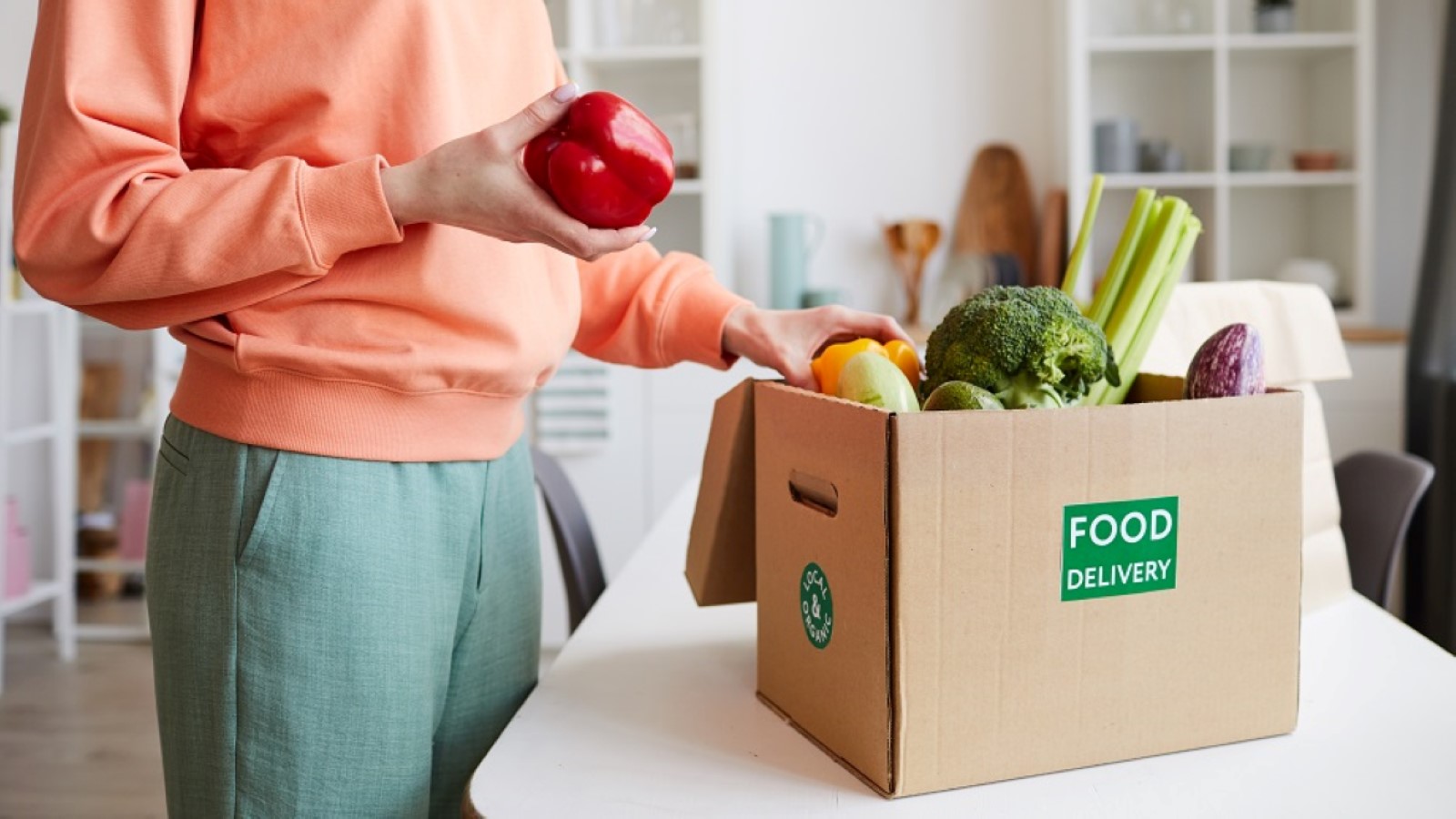 a red pepper in a persons hand